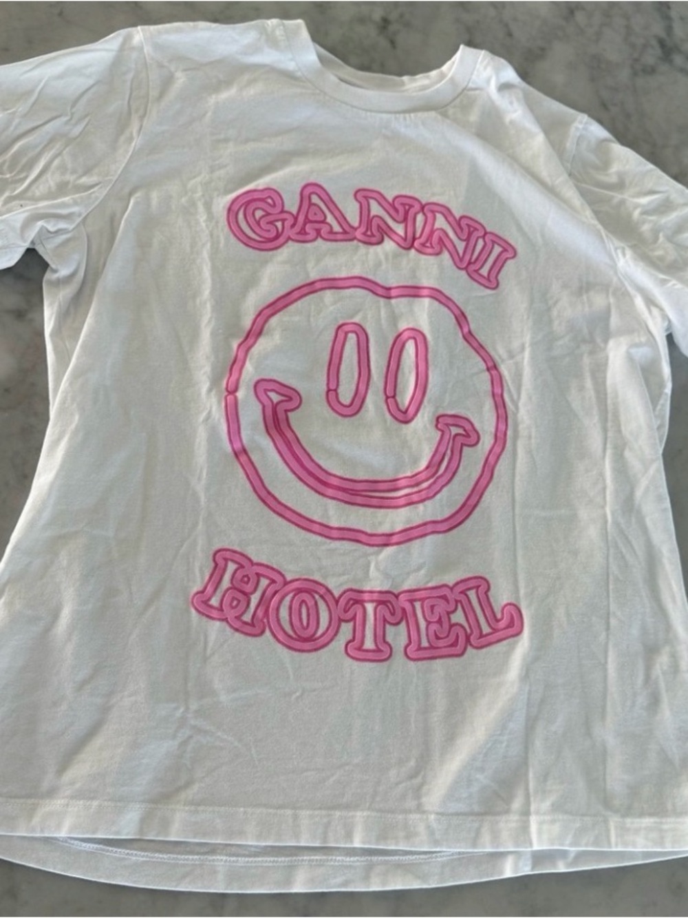 Ganni White Tee with Pink Smiley and 'GANNI HOTEL' Graphic